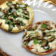 Can't decide between red sauce or white? Do both. Spinach, mushroom, and onion pizzas with Alfredo sauce, and with tomato sauce.