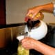 Using a funnel, pour boiling water into each jar to within 1" of the rim. With a plastic spatula, remove air bubbles. Wipe rims with a clean, damp cloth or paper towel. Put lids and rings on snugly, but not tightly.