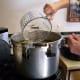 Filling the pressure canner with the appropriate measure of water.