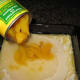 Pour peaches and canning syrup into the baking dish, over the batter.