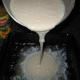 Pour the flour mixture over the melted butter in the baking dish.