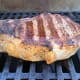 Sear one side of the steak, then flip it and smear the garlic paste on.