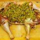 Turkey that's been deboned to use in a Turducken and stuffed. This one is ready to roll and seal for cooking.