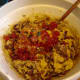 Add eggs, flour, almonds, baking powder, fruit and nuts.