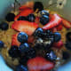 Put muesli in a bowl at breakfast time, add juice of choice and decorate with fresh fruit.