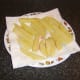 The chips are drained on kitchen towel after their first fry
