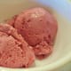 Two scoops of eggless raspberry ice cream.