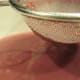 A strainer with a fine mesh will catch most raspberry seeds.