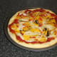 Pizza is removed from oven and allowed to rest for a few minutes