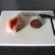 A careful, downwardly diagonal cut is made in each chicken breast to incorporate the black pudding