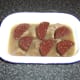 Black pudding is placed on top of the steak and stock