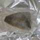 Plaice is seasoned and baked in foil with a little butter