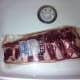 Defrosting the ribs in their plastic packaging.