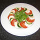 The salad is arranged on the plate, ready to receive the poached chicken wings