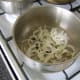 The sliced onion, black peppercorns and salt are added to a large pot