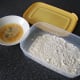 Beaten egg and flour is used to coat the chicken wings for deep frying