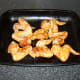 Marinated chicken wings are laid in a single layer on a large roasting or baking tray