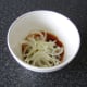 The sliced onions are added to the prepared spice mix