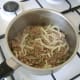 Brown the lamb in a dry saucepan before adding the thinly sliced onion and chopped mint.