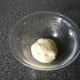 The kneaded dough is placed in to a lightly oiled bowl, covered and left in a warm place to rise