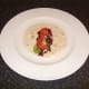 Salad leaves and tomato slices are added to the tortilla wrap