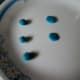 Make the iris by flattening pea-sized balls of blue mixture