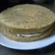 Add another layer of 1/4 of the frosting. The second cake layer is placed upside down on the first layer.