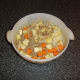 The beef and vegetables are firstly spread on the bottom of the casserole dish