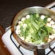 Chopped vegetables are added to the quail stock