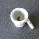 Black peppercorns are crushed in a pestle and mortar