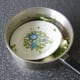 The weight of a plate keeps the quail submerged in the water