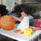 Carving their Pumpkins into Jack-O-Lanterns