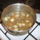 Chicken livers, vegetables and stock are added to a large stew pot