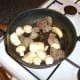Mushrooms and onion are briefly added to the pan