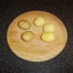 The skin is rubbed off the cooked and cooled potatoes prior to deep frying