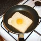 The egg is poured on to the bread that the yolk slips in to the hole