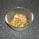 Salsa ingredients are mixed in a bowl, covered with plastic wrap and refrigerated