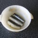 Sardines are laid on drizzled olive oil in a casserole dish