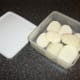 Parboiled potatoes are refrigerated in a plastic dish.