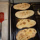 Naan bread on the griddle.