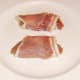 Partridge breasts are carefully wrapped in bacon