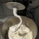 KitchenAid mixer with dough hook and bowl inserted.
