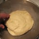 Completed dough turned into greased bowl for rising.