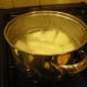 Potatoes cut in pieces, boiling.