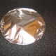 Pork chop is covered with foil to rest
