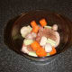 Pork and vegetables are added to casserole dish and seasoned