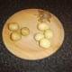 Peeling the cooked potatoes for roasting