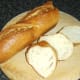 Slices are cut from French bread stick for toasting