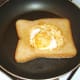 Duck egg bread is carefully turned in pan