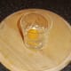 Duck egg is carefully broken in to drinking glass